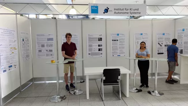 A2S Tag der Forschung 2023 stand setup with all posters and a few presenters