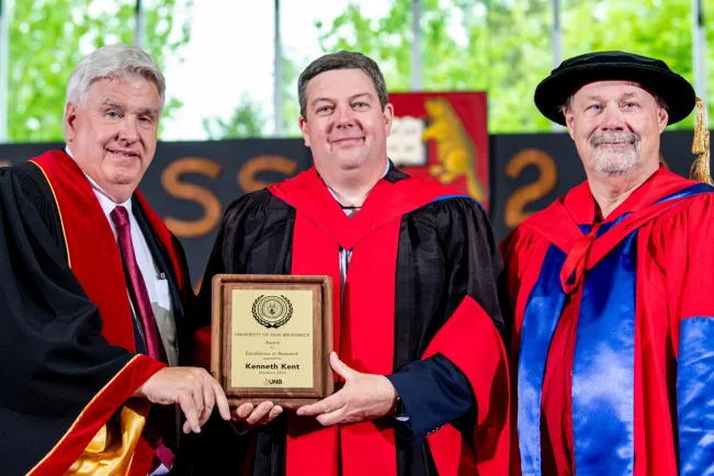 UNB Predident Paul Mazerolle (l), Kenneth Kent and UNB Vice-President David MaGee